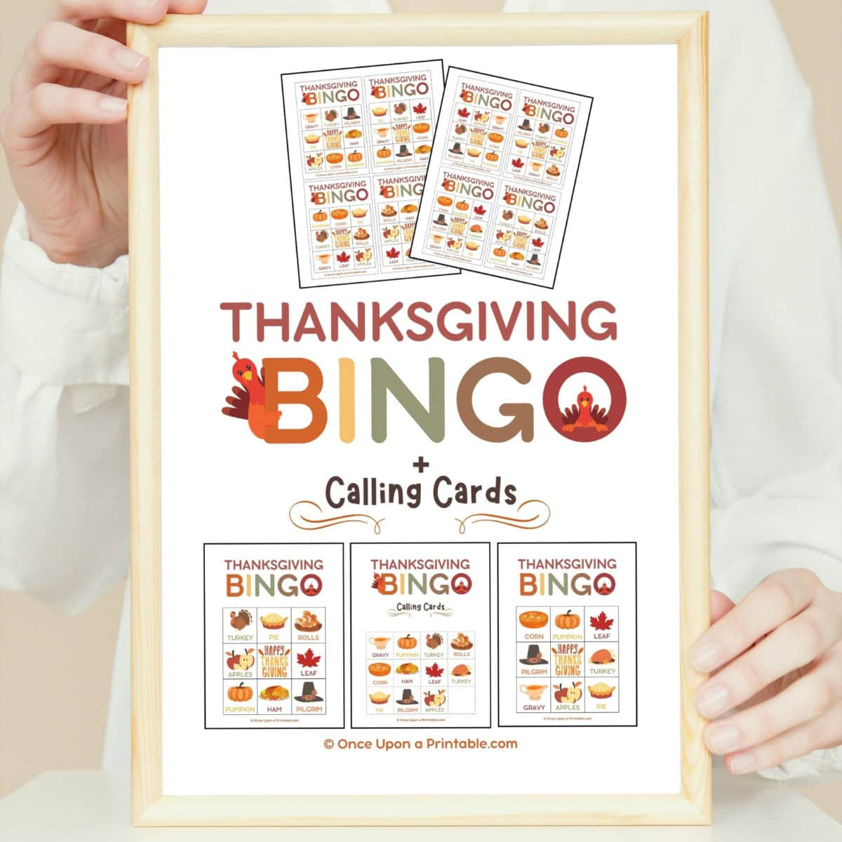 Thanksgiving bingo cover page with bright colors and turkey graphics framed and held in a womans' hands.