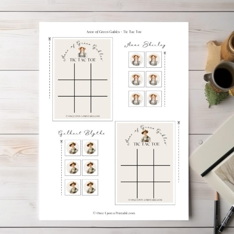 Anne of Green gables tic tac toe card with anne shirley and gilbert blythe, laying on a table with a pen and paper.