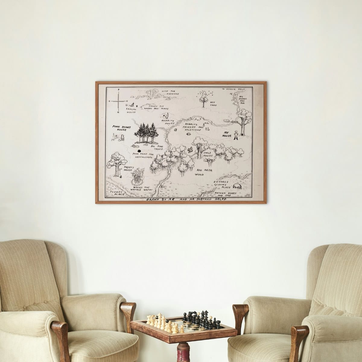 Hundred acre wood from the Winnie the Pooh book by A. A. Milne drawn by E. H. Shepard displayed above two sitting chairs and chess.