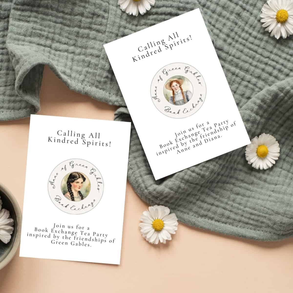 Anne and Diana book exchange invitations laying on a green blanket with daisies.