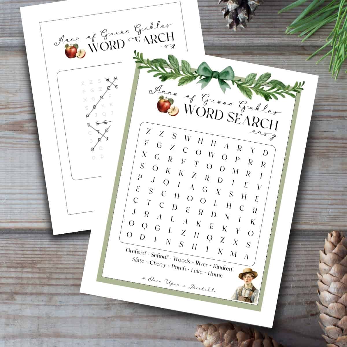 Easy word search puzzles inspired by Anne of Green Gables laying on a wooden background with pinecones.