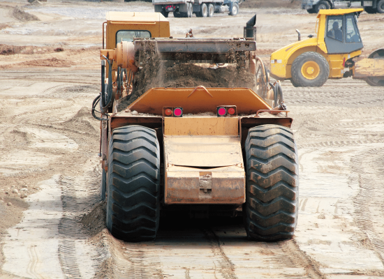 Compacting soil to create a stable construction base
