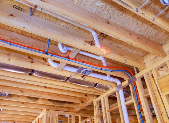 Commercial plumbing team installing new pipeline in office building
