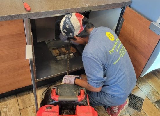 Licensed technician inspecting residential plumbing system