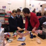 pupils creating xmas shoe box parcels