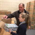 pupils creating xmas shoe box parcels