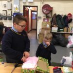 pupils creating xmas shoe box parcels
