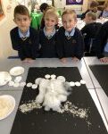 pupils looking at a white garment