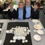 pupils looking at a white garment