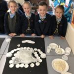 pupils looking at a white garment
