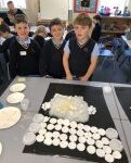 pupils looking at a white garment