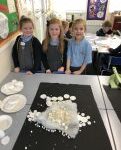 pupils looking at a white garment