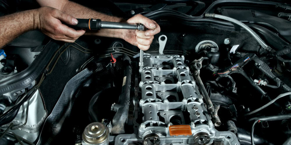automotive repair guy working on car