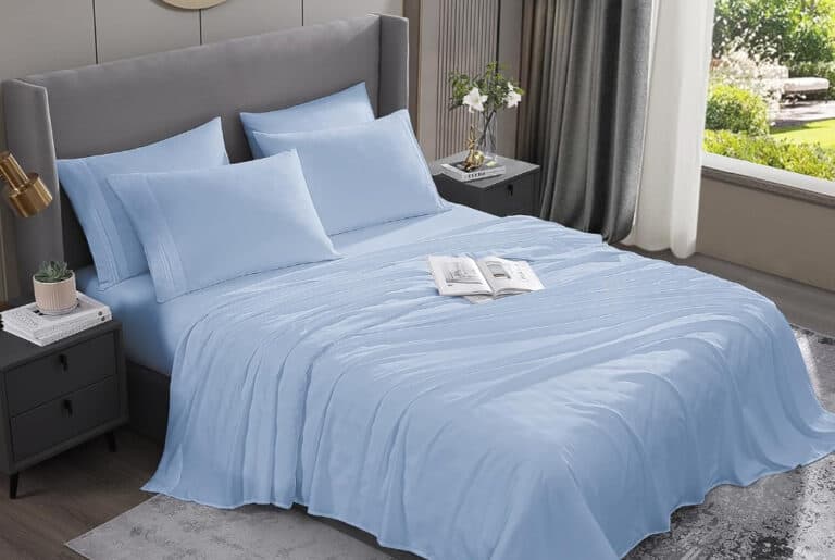 Blue bed with pillows and open book