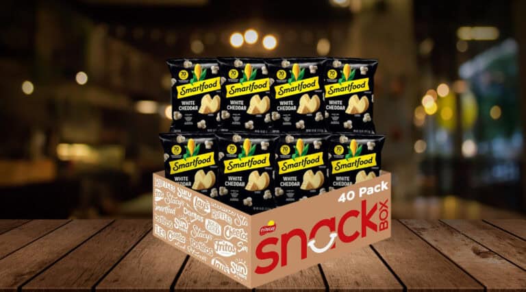 Smartfood White Cheddar popcorn snack pack on table.