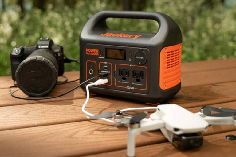 Portable power station, camera, and drone on table