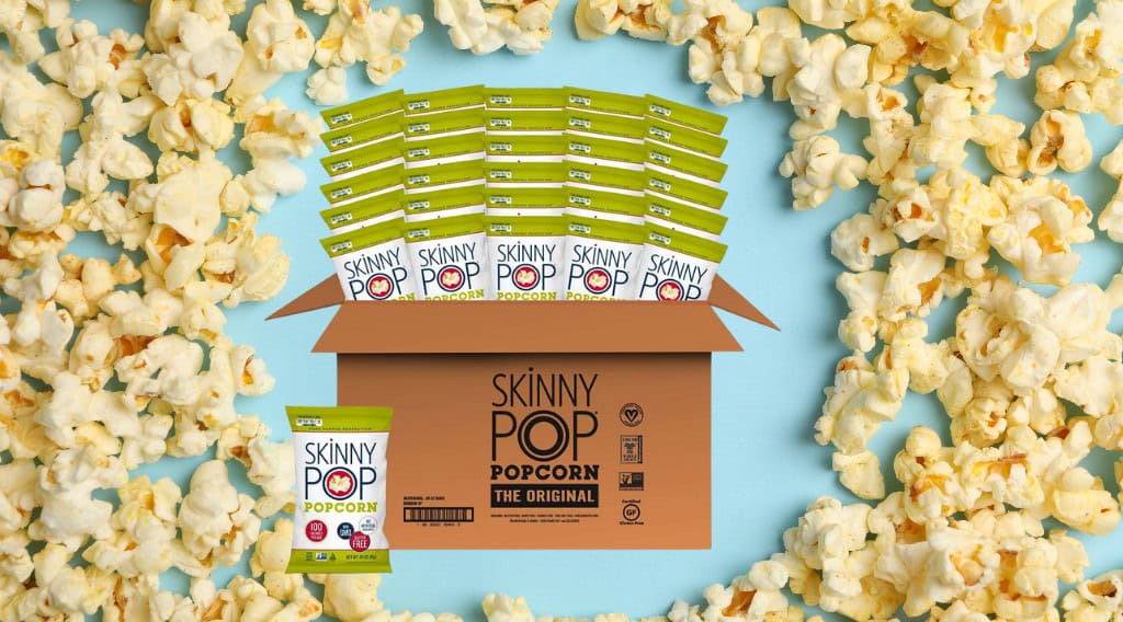 SkinnyPop popcorn packs overflowing from box