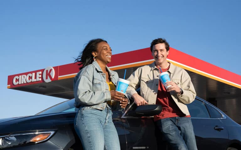 Two people with drinks at Circle K gas station.