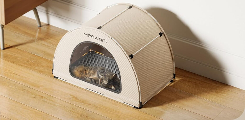 Cat sleeping in cozy pet tent on wooden floor.