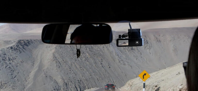 Driving on mountain road with dashcam view ahead.