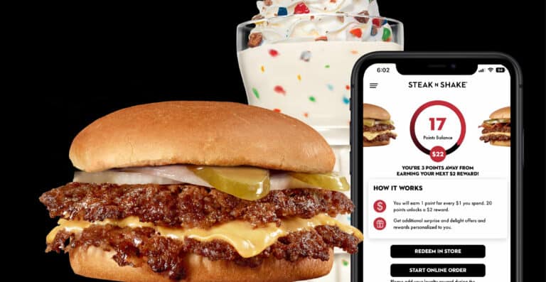 Burger and milkshake with loyalty app on phone.