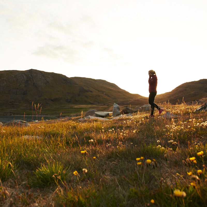 A woman talking on the phone and strolling through Inneruulalik