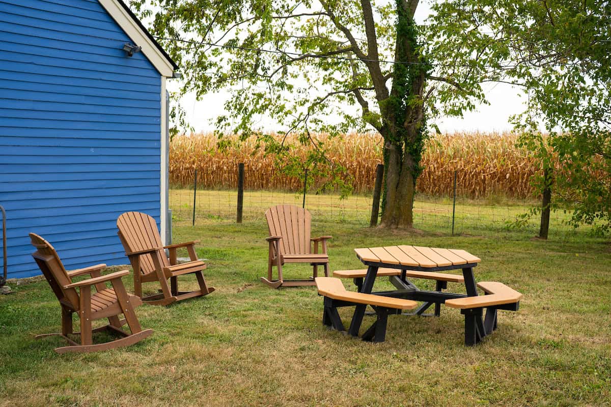 Outdoor living space on a large farm in Northern Garrard county with rocking chairs and picnic table