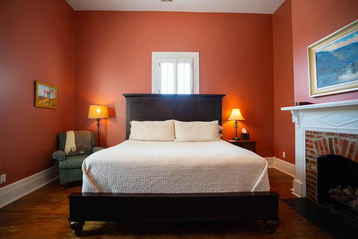 The house is made up of a two-story log cabin that was once part of a school that is rumored to have taught a Kentucky governor. A Victorian addition was built in the late 1800s and gives the two downstairs bedrooms tall ceilings and light. The third bedroom is in the loft of the cabin and accessed by a ladder. There is a king bed and a queen bed on the main floor and a full-size bed in the loft. The living area has a wood-burning stove and a queen sleeper sofa.