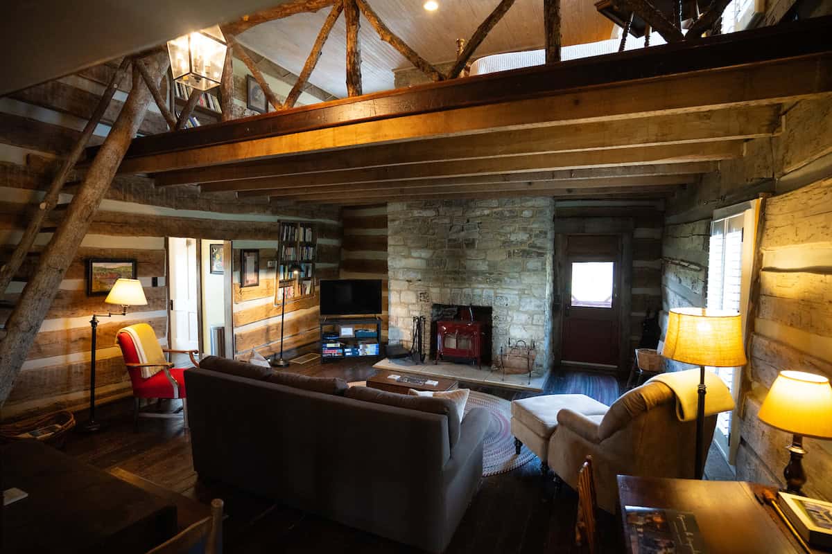 Fisher Ford house - The living area has a wood-burning stove and a queen sleeper sofa.
