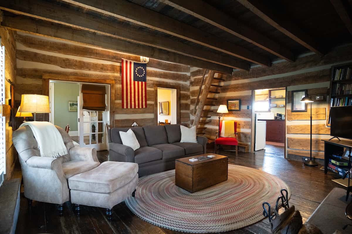 Fisher Ford house - The living area has a wood-burning stove and a queen sleeper sofa.