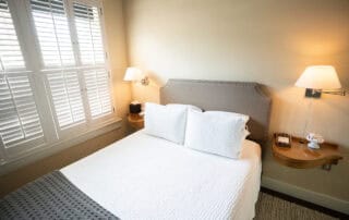 We offer eight guest rooms with queen beds and small ensuite baths. Some amenities include luxury bedding, flat-screen televisions, high-speed wireless internet, blackout shades, and our handcrafted Plainview Farm toiletries. We also provide filtered water and Nespresso makers in the kitchenette near the rooms and a small sitting area for reading or working. The kitchenette has a microwave, refrigerator drawer, and freezer drawer for use by guests. Nearby is a washer and dryer, also available for guest use.