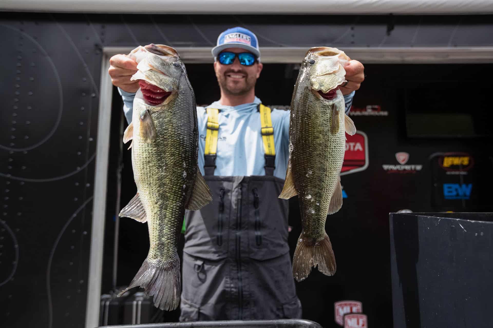two fish being held by pro-angler in cedar creek lake