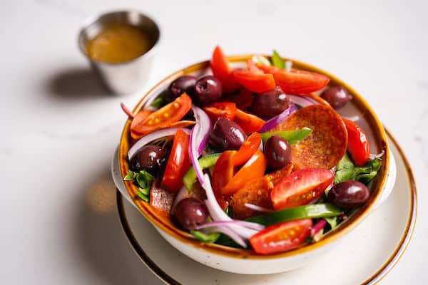 Italian Salad - Mixed lettuce with tomato, red onion, olive, green pepper, and pepperoni with a wine vinaigrette from Mama DeVechio's Pizzeria