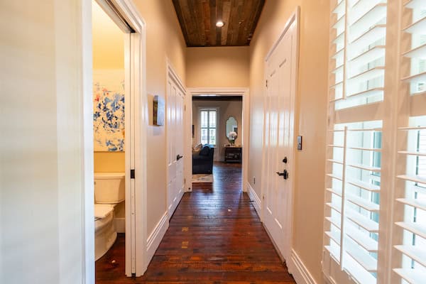 Wide and bright hallway with natural light leading from Master bedroom to kitchen, dining room and living area at the Hart House