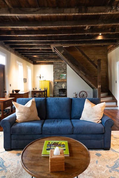 Living space on the first floor of the Hart House with both a wood-burning stove and gas fireplace.
