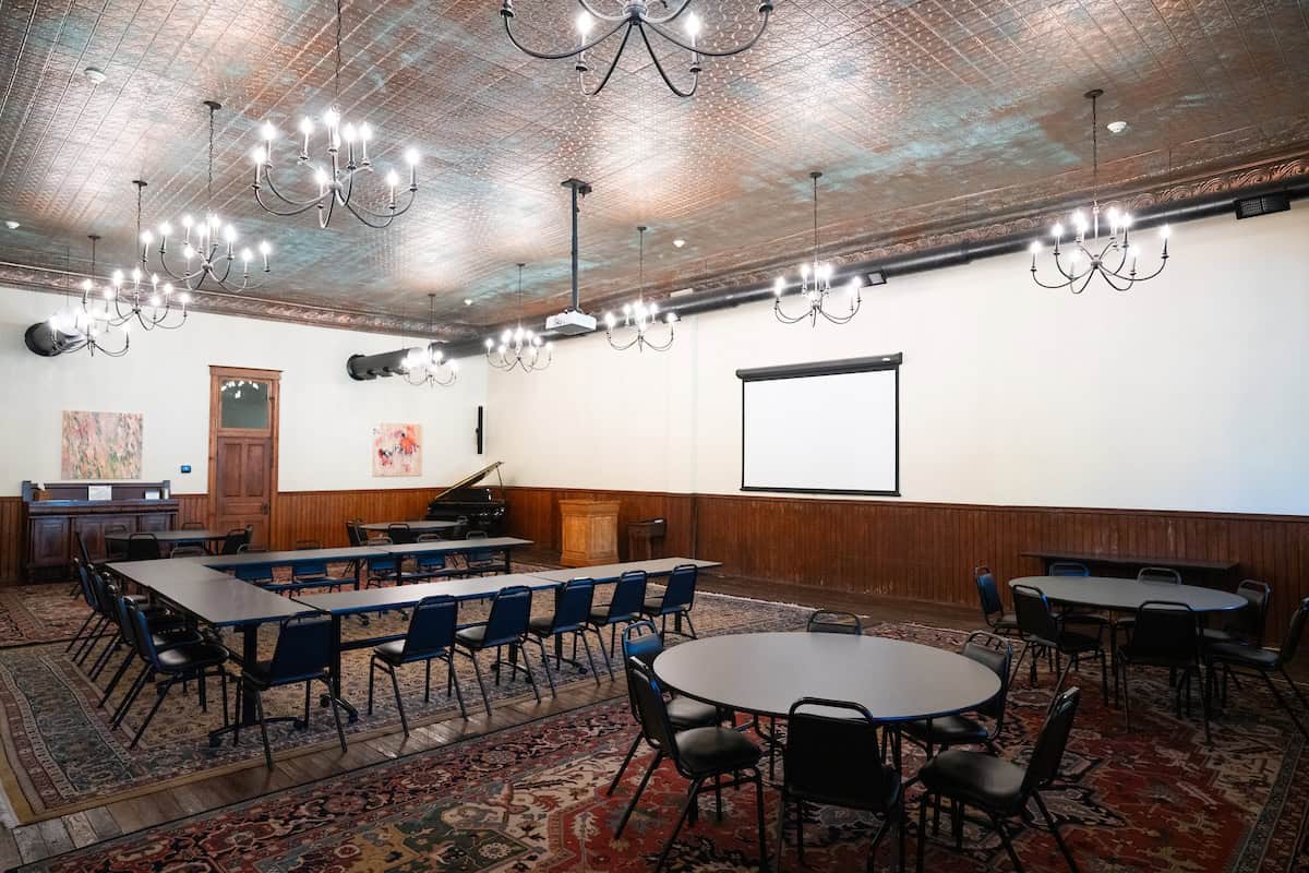 Ballroom set up with tables and chairs available for corporate meetings or retreats at The Stanford Inn