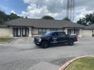 a Dolan vehicle in front of the Cedar Park office complex