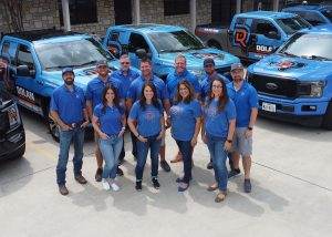 Dolan team photo in front of company trucks San Antonio, TX