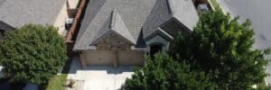 Aerial drone view of residential roof showing damage for insurance claim by Dolan Roofing & Construction in San Antonio