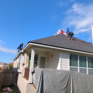 House with grey roof and white siding in a process of roof replacement in San Antonio, TX
