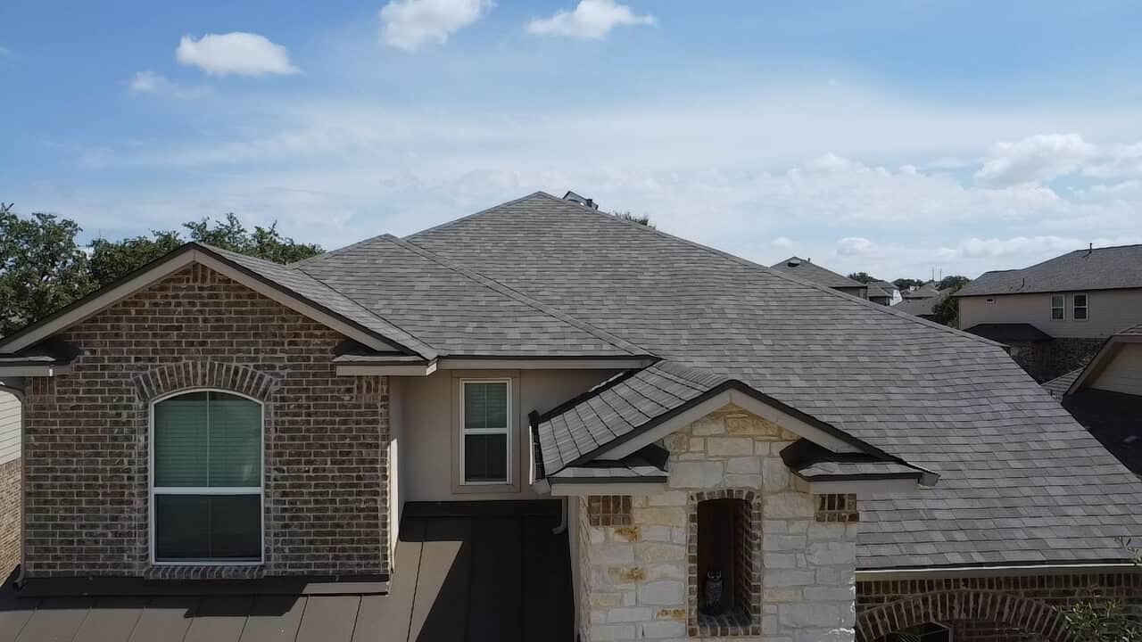 Newly repaired black residential roof in San Antonio, TX