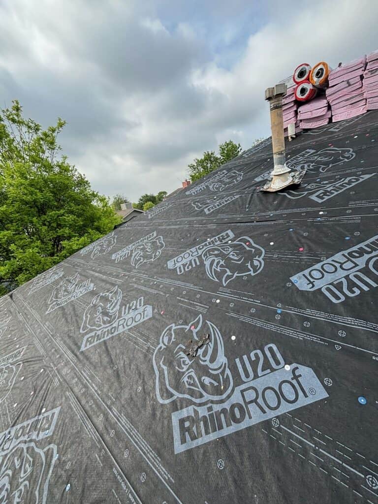 Top view showing the asphalt shingle installation process on a residential roof