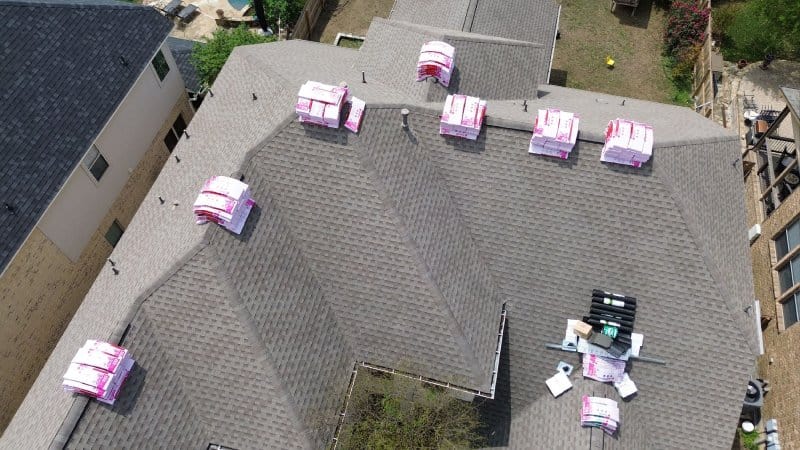 Aerial view of a new asphalt roof installation