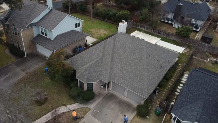 Full property aerial showing Owens Corning Oakridge Driftwood shingle roof and landscaping by Dolan Roofing & Construction in Oakridge