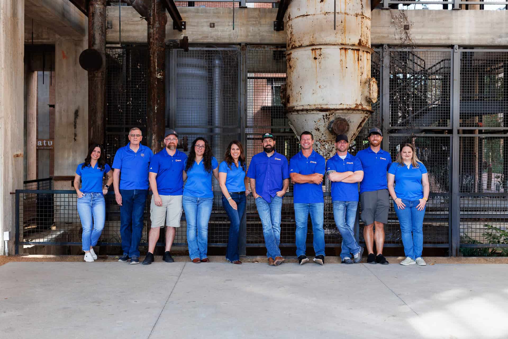 Dolan Roofing & Construction team photo in older factory setting