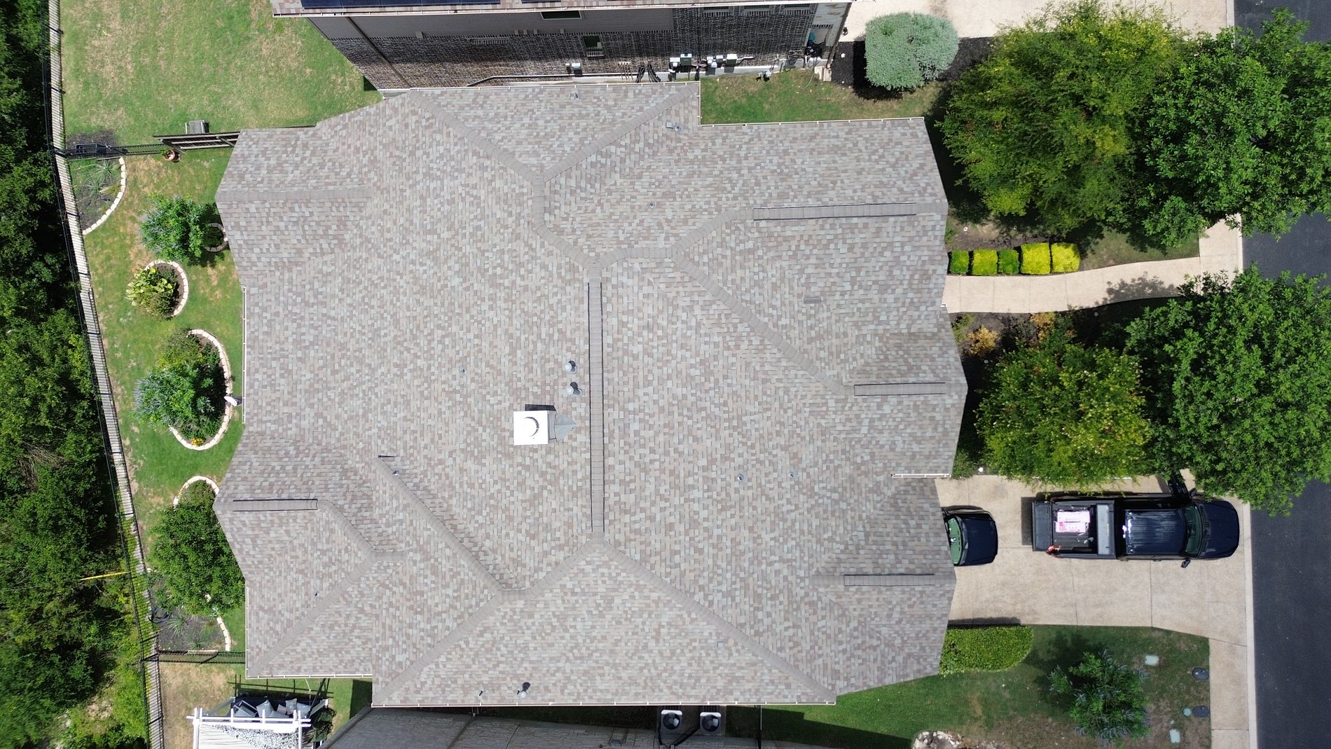 Roof ridge cap and pipe vent with Owens Corning Duration Driftwood shingles installed by Dolan Roofing & Construction in Driftwood