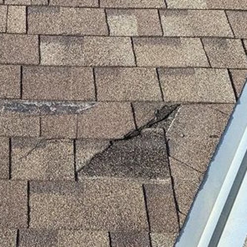 Roof damaged by storm being repaired by Doolan Roofing in San Antonio.
