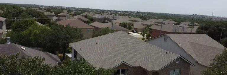 Aerial photo of suburban rooftops used in home insurance cancellation San Antonio inspections by Dolan Roofing & Construction in San Antonio