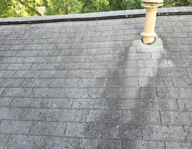 ariel view of damaged roof shingles from age crews working on top of a roof to replace damaged shingles Dolan Roofing & Construction in San Antonio, TX
