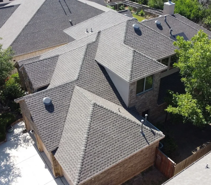 Top view showing the asphalt shingle installation process on a residential roof
